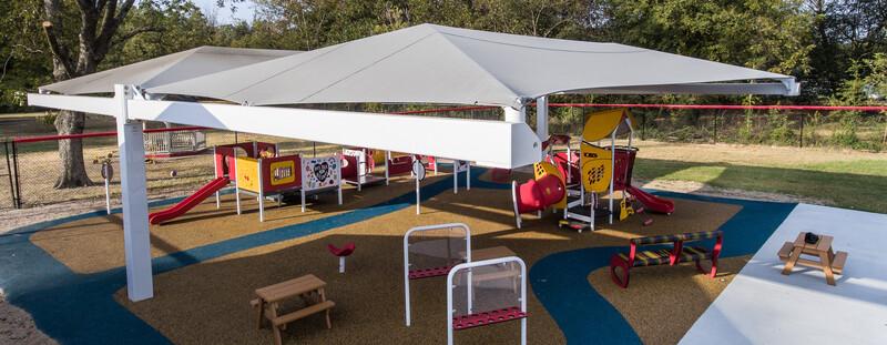 As part of Pooh Bear Daycare Center, this smart play playground sits under a shade canopy as the sun sets.