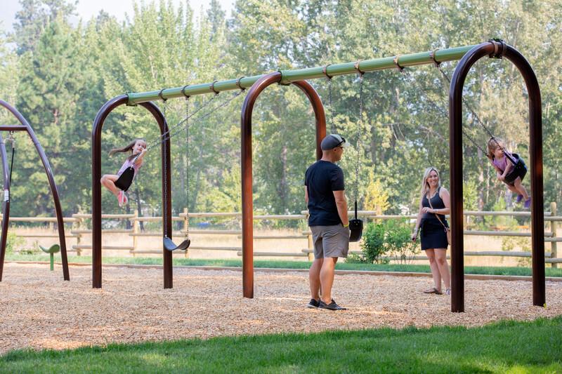 Families play on 5" Arch Swing Frame Additional Bay
