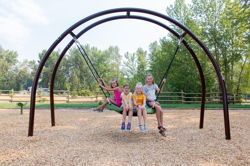 Girls sitting and smiling on Oodle® Swing