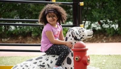 Girl siting on Dalmatian statue