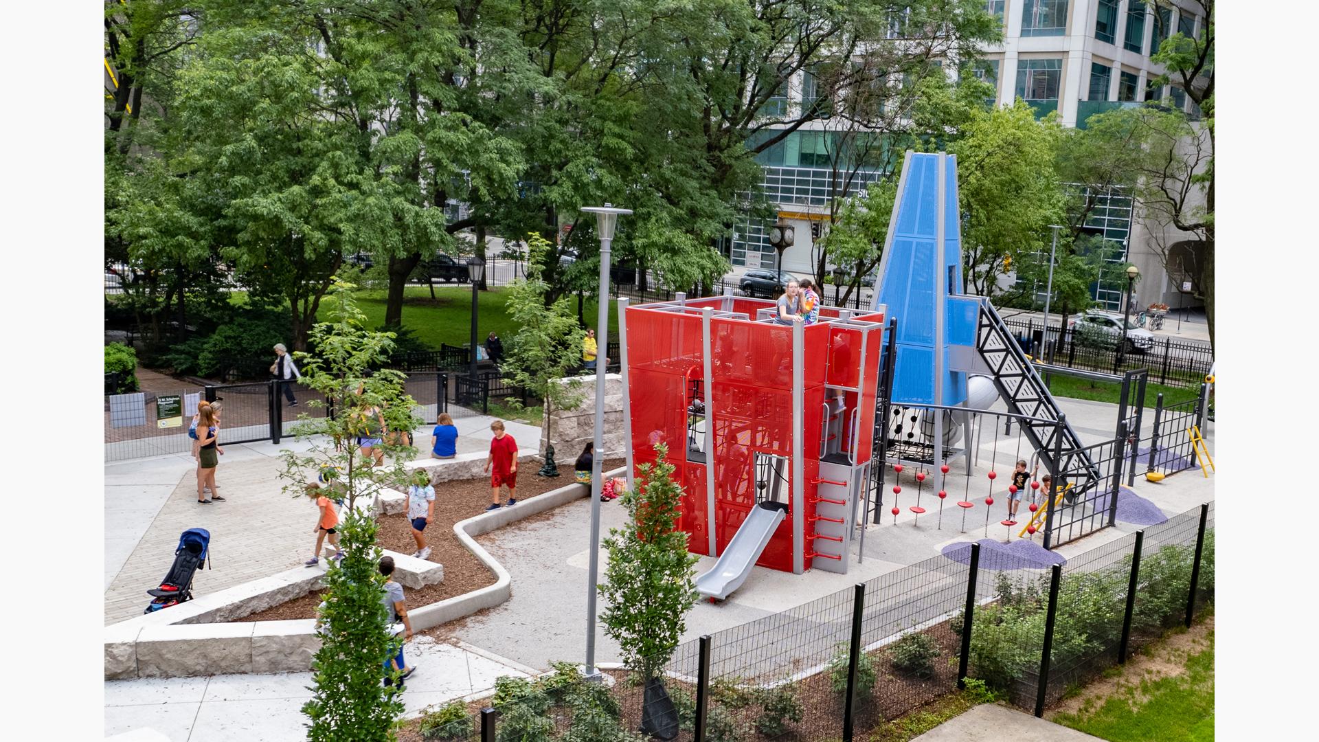 Children playing on custom play structures at Seneca Park, Eli M. Schulman Playground