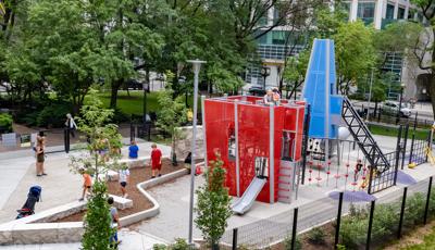 Children playing on custom play structures at Seneca Park, Eli M. Schulman Playground