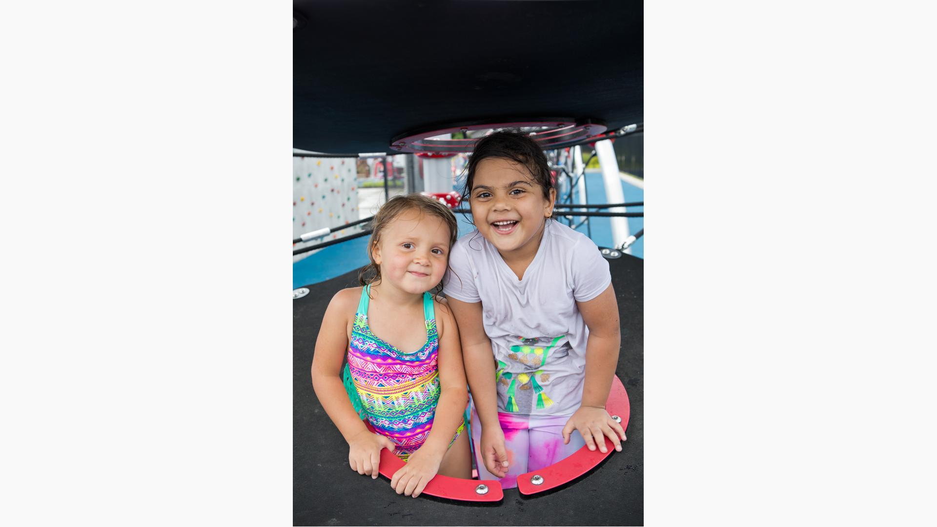 Two girls smiling whiling sitting in disc set