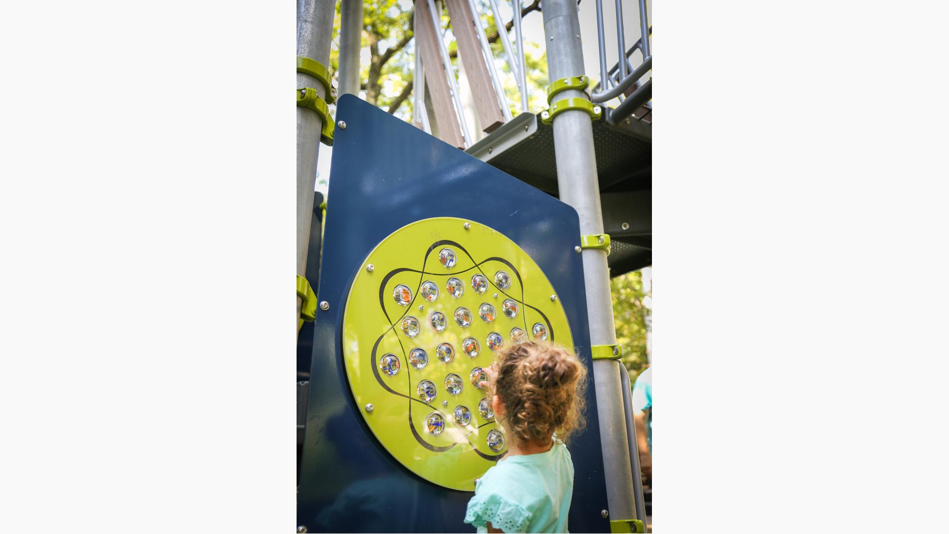 Girl playing on learning wall