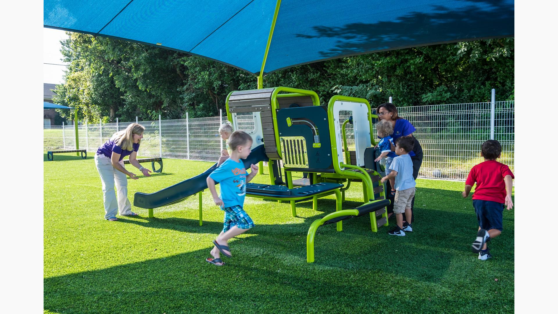 Blue & green playsmart play structure being surrounded by kids from Smart Start Childcare Center.