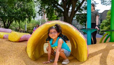 Girl sitting in tunnel structure