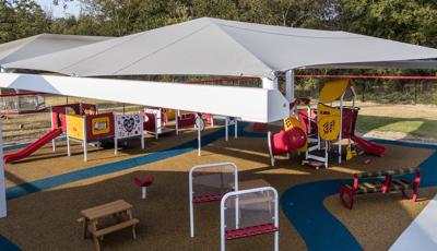 As part of Pooh Bear Daycare Center, this smart play playground sits under a shade canopy as the sun sets.