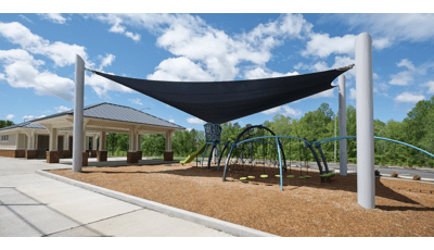 Custom Skyways Shade panel covers this Evos playground next to a ball field.