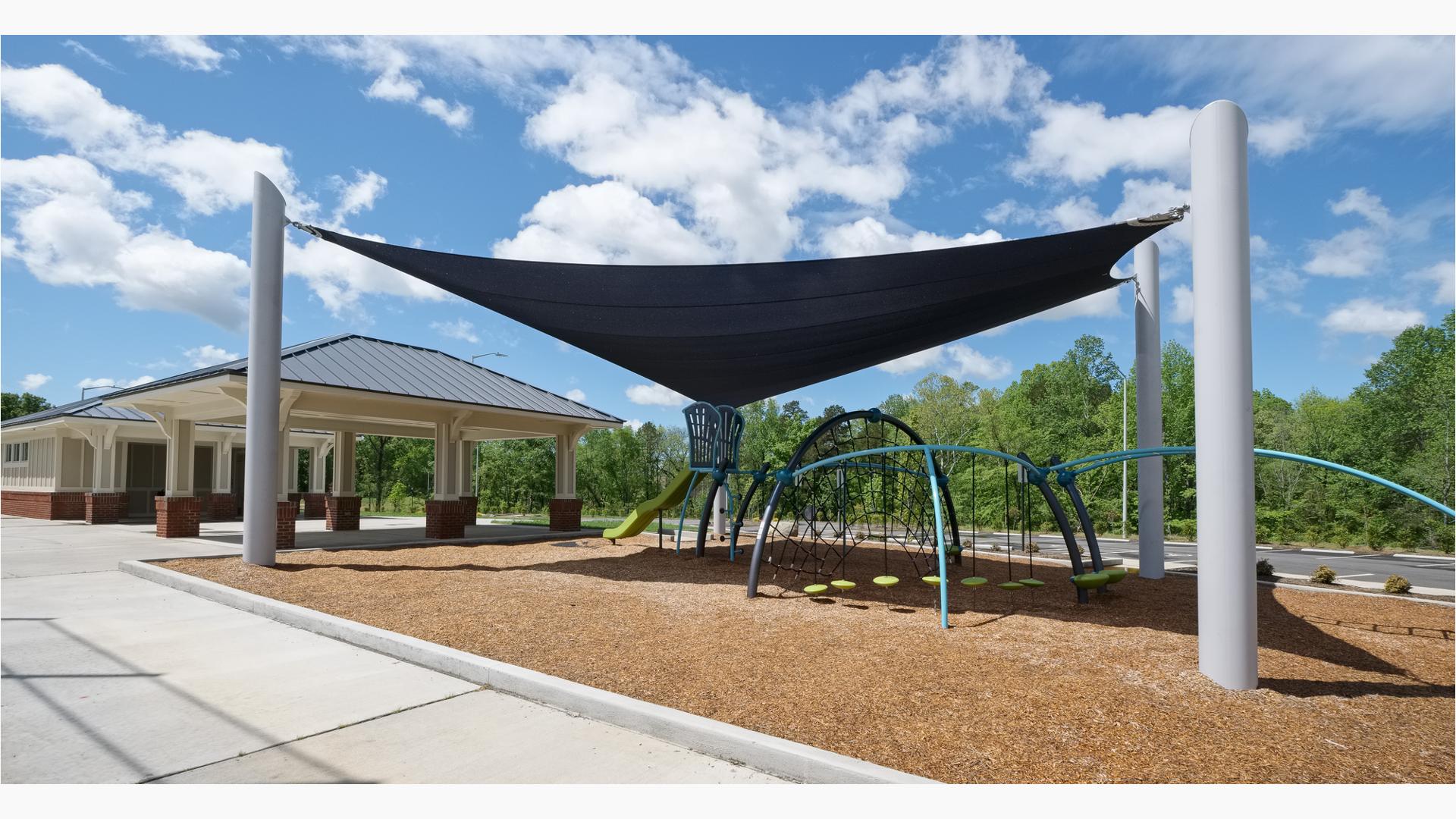 Custom Skyways Shade panel covers this Evos playground next to a ball field.