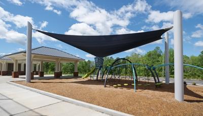 Custom Skyways Shade panel covers this Evos playground next to a ball field.