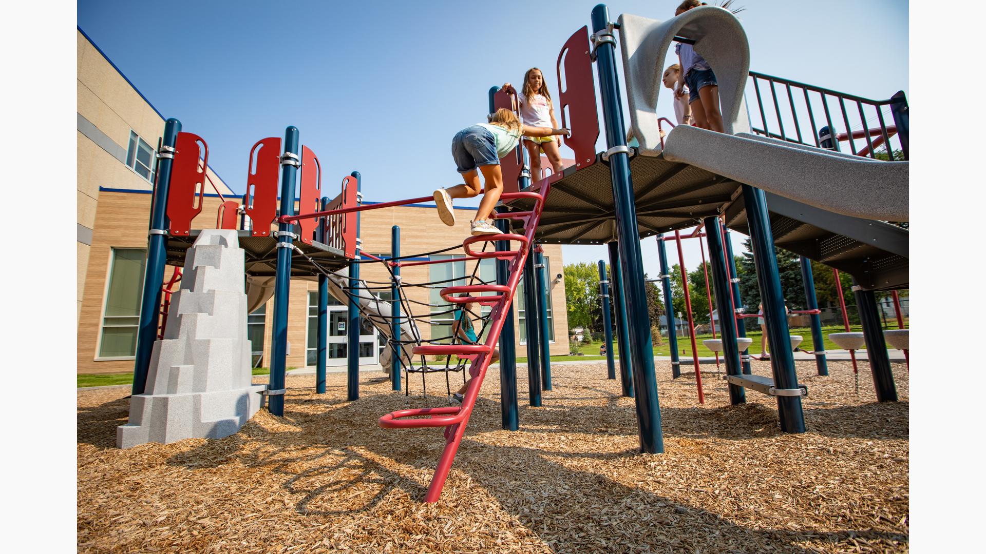 Girl in jean shorts climbing to the top of Square Loop Incline Climber