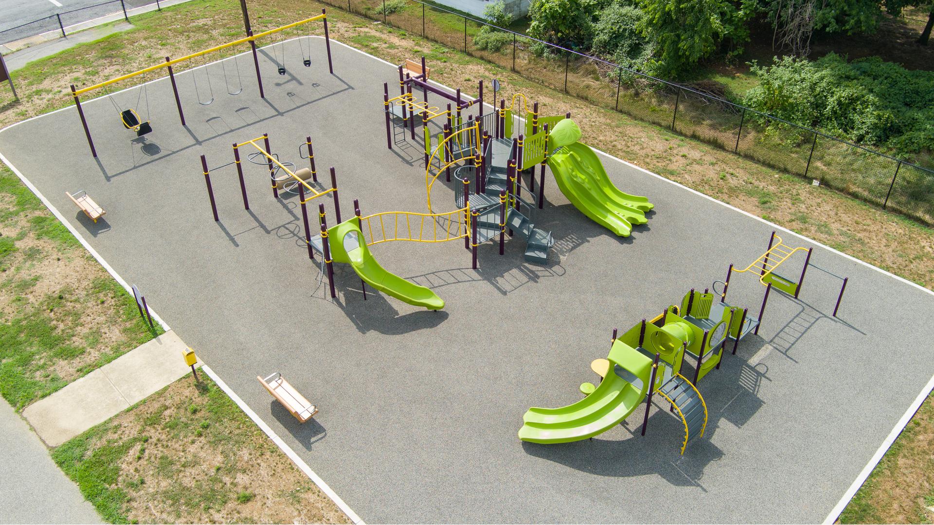 Elevated view of a neighborhood park with two main play structures and several bays of swings.