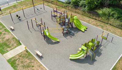 Elevated view of a neighborhood park with two main play structures and several bays of swings.