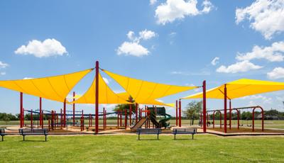 Holly Bay Park in Pasadena, TX houses PlayBooster® playstructure, OmniSpin® Spinner and ZipKrooz® and is nestled under SkyWays® Shade products.