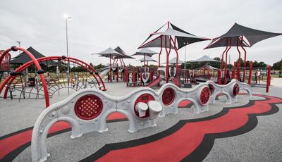 All inclusive playground featuring Evos and PlayBooster equipment. The playground has a custom surface and shade coverings over each of the play structures.