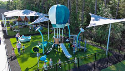 Elevated view of three play areas designated for the age groups of the childcare facility.