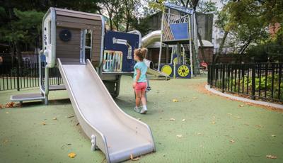 Girl standing next to Play Shaper slide