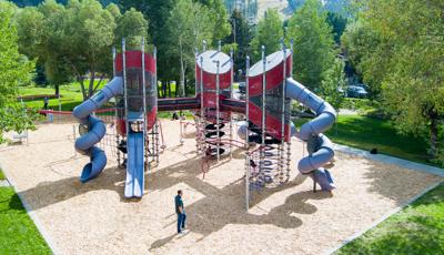 Elevated view of a three tower playground structure connected by elevated crawl tunnels.