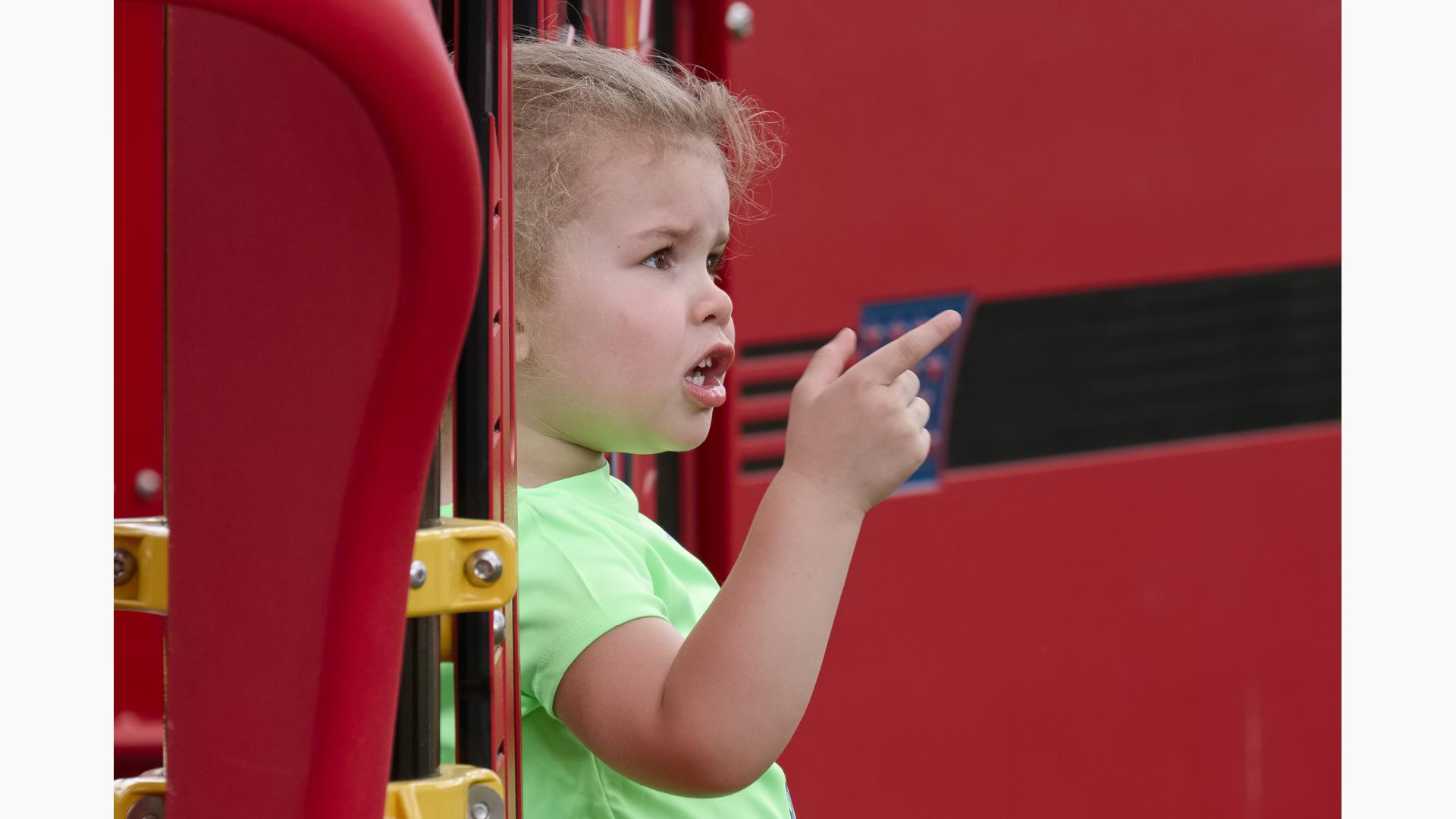 Little girl in green shirt pointing