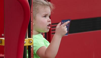 Little girl in green shirt pointing