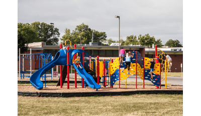 Children playing on the playground at Prairie Queen Elementary.
