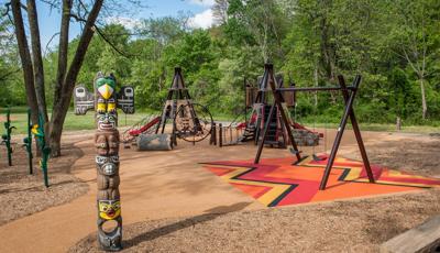 Surrounded by forest, this custom Native American-themed playground combines playtime and history.
