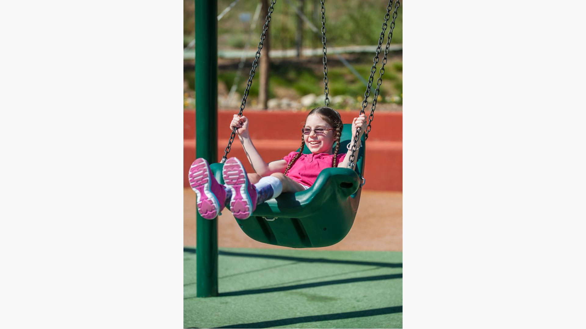 Girl swinging in Molded Bucket Seat w/Chains