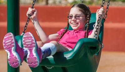 Girl swinging in Molded Bucket Seat w/Chains