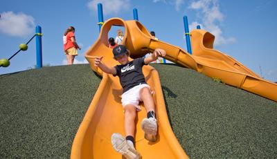 Boy riding down slide