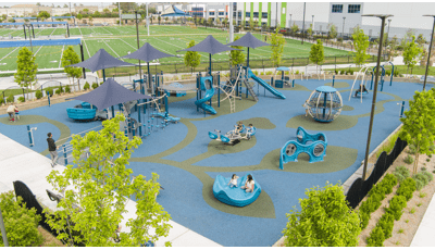 Elevated view of a triangular shaped play area colored in blue and greens with inclusive play activities for all abilities.