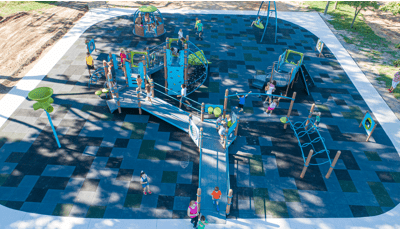 Elevated view of a playground equipped with assessable ramps and playground safety surfacing for all abilities. 