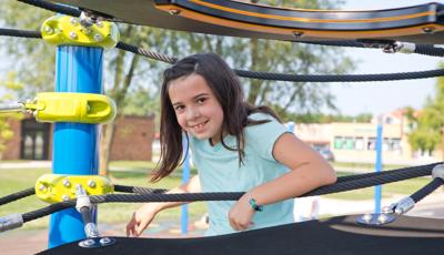 Girl smiling on Netplex® play structure