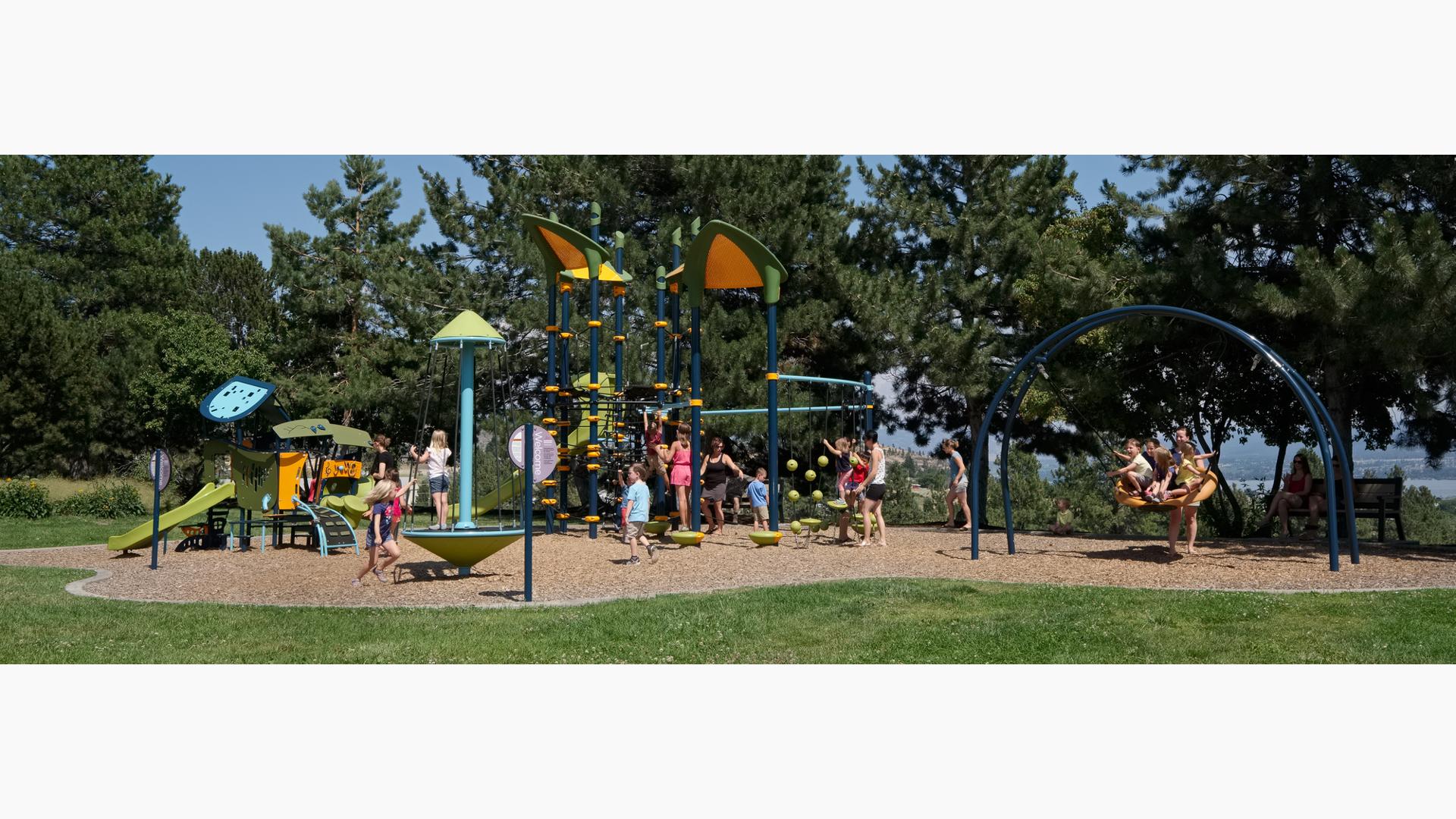 Memorial Park, West Kelowna, BC. features a Netplex® play system. Slides, overhead ladders and SquiggleKnots™, Oodle® Swing and TopsyTurny® Spinner and the Motion play structure from the Smart Play®.