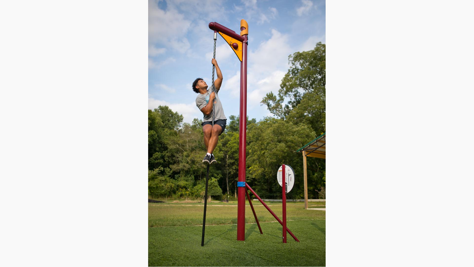 Boy doing gymnastics on two rings hanging ropes Vector Image