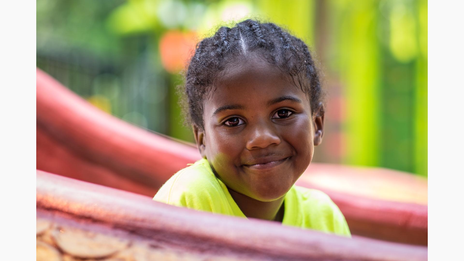 Kids and sport. Side view of a happy little girl smiling at camera