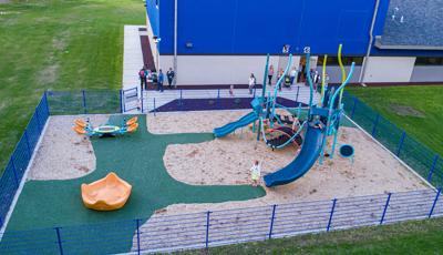 Families walking out to see Up North Learning Center playground with Smart Play play structure.