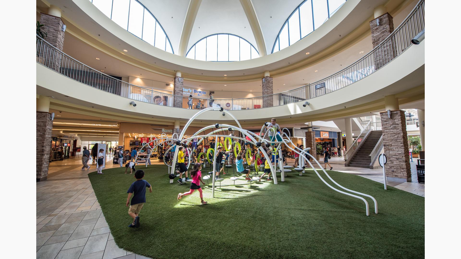 Lougheed Town Centre Burnaby, BC. An Evos® play system for ages 5 to 12 features the O-Zone® rings, Hemisphere Climber®, RingTangle™ climber, SwiggleStix™ bridge