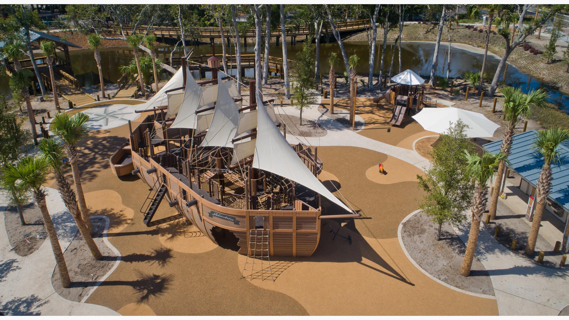 Elevated view of a large custom playground designed like a life-sized pirate ship.