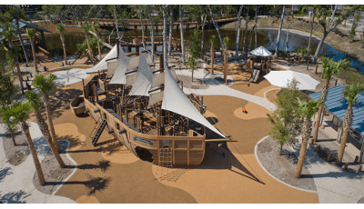 Elevated view of a large custom playground designed like a life-sized pirate ship.