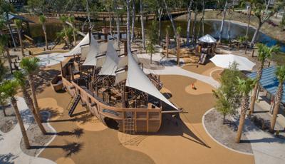 Elevated view of a large custom playground designed like a life-sized pirate ship.