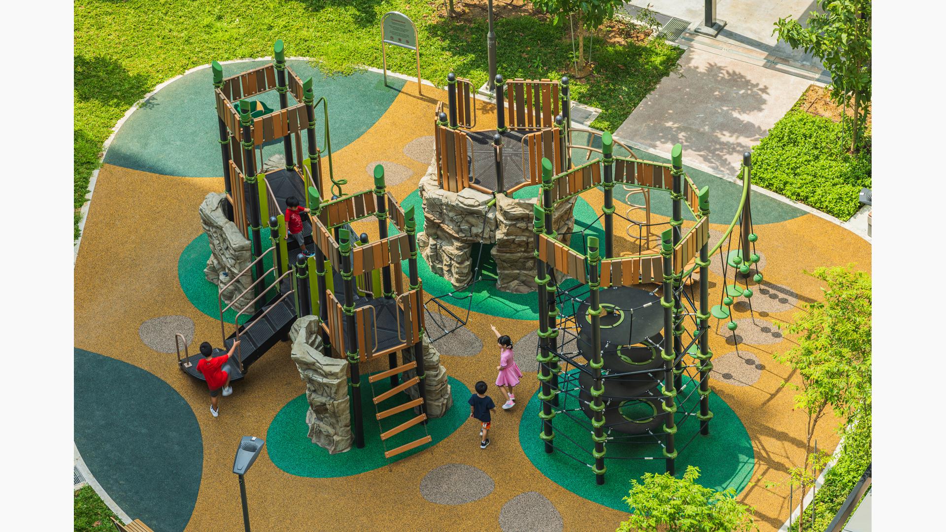 Elevated view of multiple towered structures with rope, rock climbers, and imitation wood paneling.