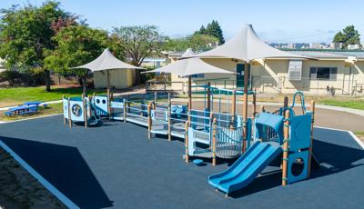 Elevated view of a school playground with dark blue safety surfacing.