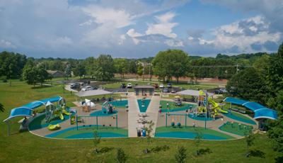 Very large playground with tall towers and shaded seating. The playground has many different play areas for kids of all ages
