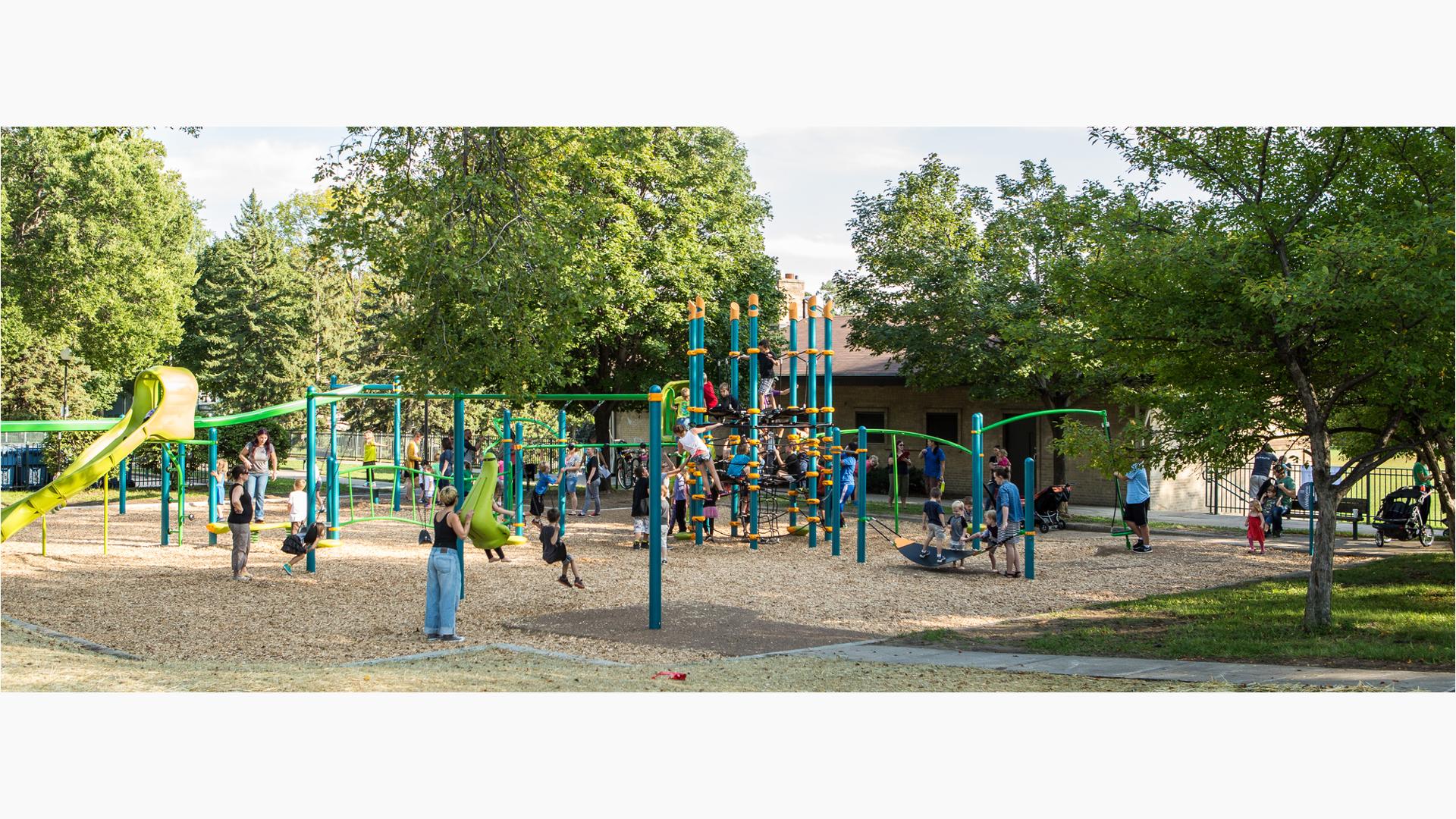 Wood Ranch Playground where kids and families have packed in the playground. The Netplex is especially overrun with playful children. Mothers push their kids on the swings as a dad pushes kids on a Boogie board.
