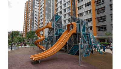 A play structure near tall apartment buildings.