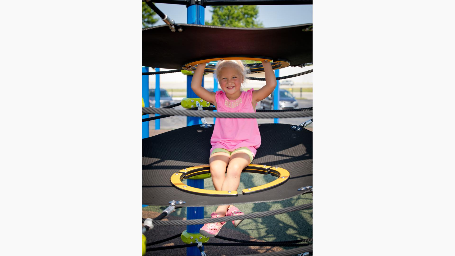 Girl sitting Netplex play structure