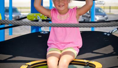 Girl sitting Netplex play structure