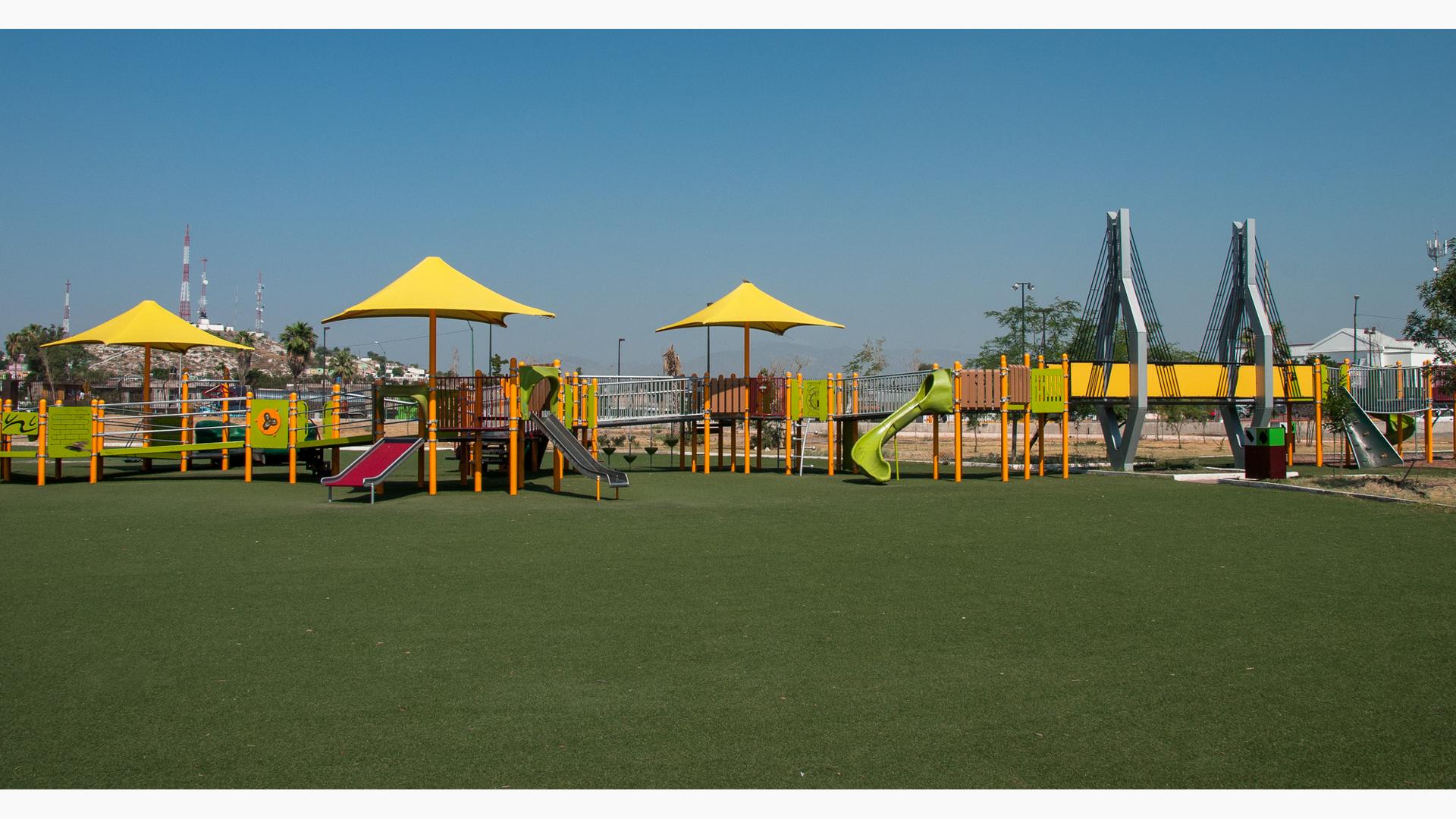 Inclusive playground with lots of ramps and shade with green synthetic surfacing. There is a bridge that is mimic to the famous Baluarte Bridge. 