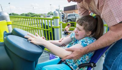 Girl learning to use Bongo Reach Panel