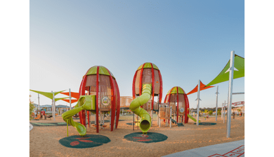 Faye Carr Park Ripley Australia featuring three rocket-shaped tower play structures for 5 to 12.  In addition a Cube play structure for kids ages 2 to 5, and to round out this play environment, a double ZipKrooz®, Global Motion®, We-saw™.